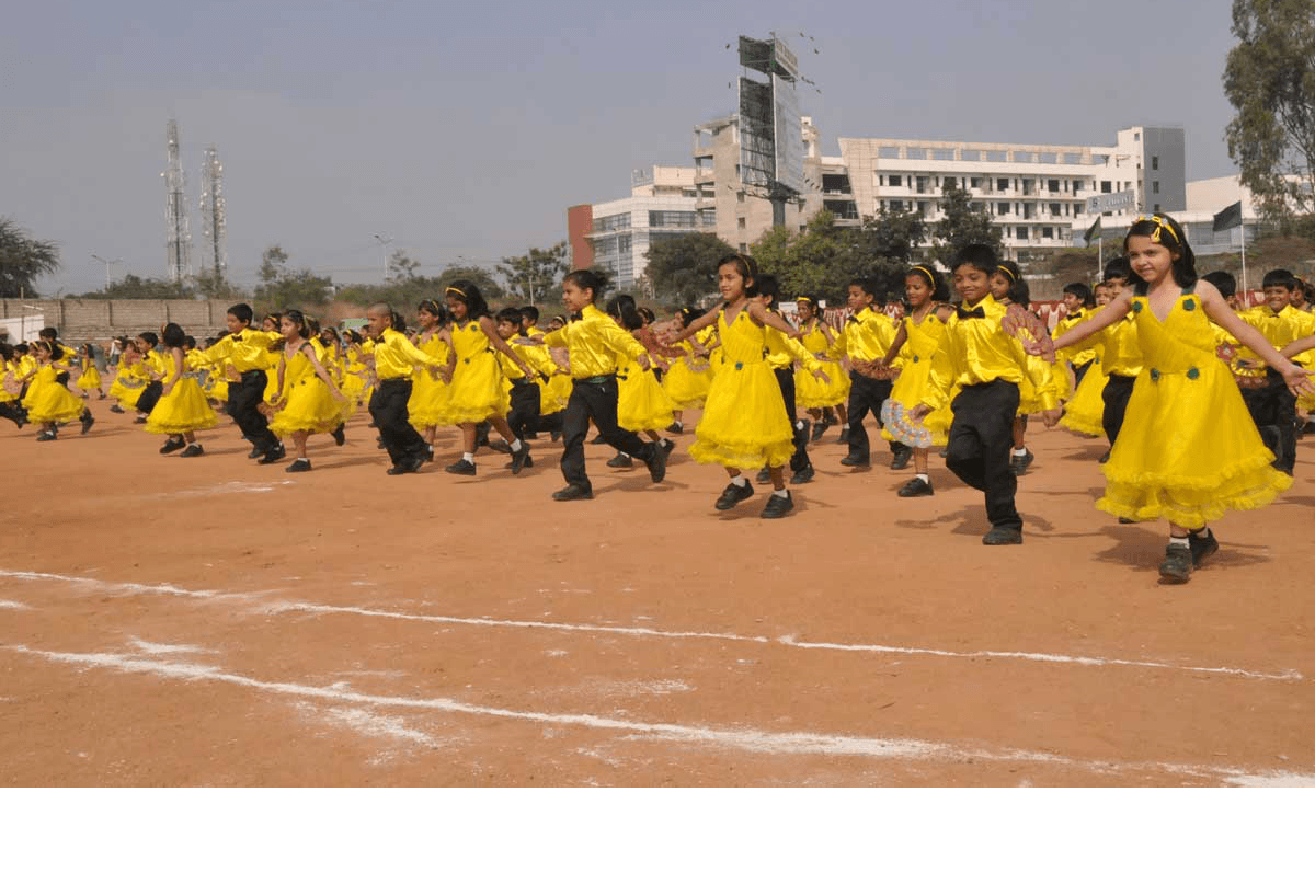 Students performing in coordinated costumes at a school annual day event